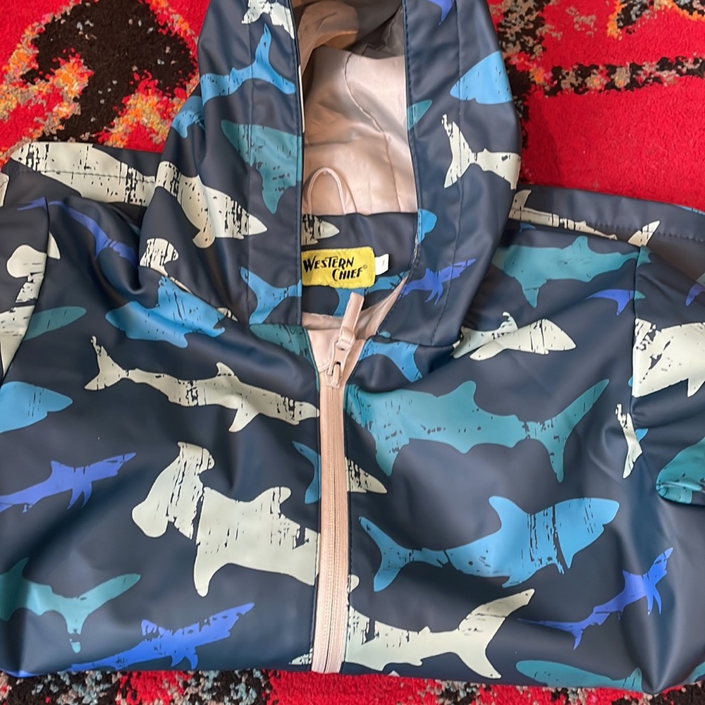 Kids size 7 shark raincoat blue with gray lining. Pockets zip up